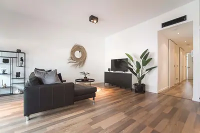 a living room with a couch and a table at Sack-Time fashion boutique hotel 6 & 7 in Zandvoort