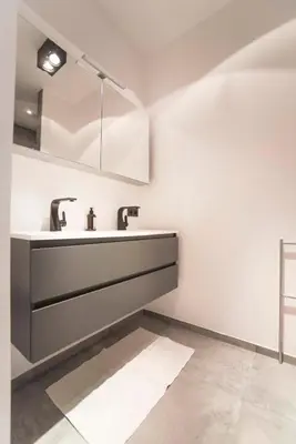 a bathroom with a sink and two faucets at Sack-Time fashion boutique hotel 6 & 7 in Zandvoort