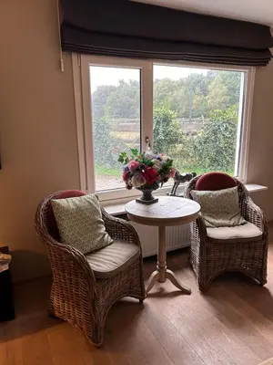 a room with a table and two chairs and a window at Veld en Bosch in Leusden