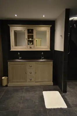 a bathroom with two sinks and a mirror at Veld en Bosch in Leusden