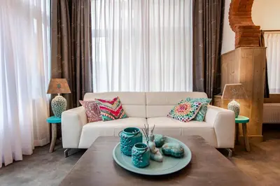 a living room with a white couch and a table at Beach Studio Boom in Zandvoort
