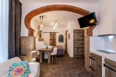 a kitchen and living room with a couch and a table at Beach Studio Boom in Zandvoort