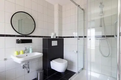 a bathroom with a toilet and a sink and a shower at Seapoint - Sea view in Zandvoort