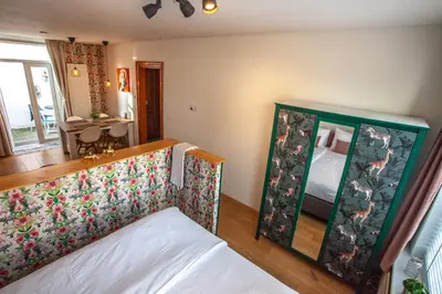 a bedroom with a bed and a mirror at Oosterhouse in Zandvoort