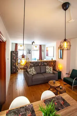 a living room with a couch and a table at Oosterhouse in Zandvoort