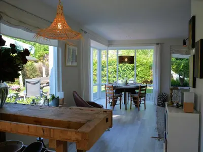 a kitchen and dining room with a table and chairs at Holiday Home in Noordwijk near the Beach in Noordwijk