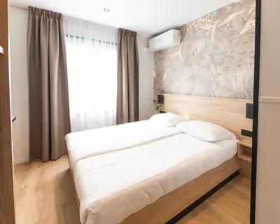 a bed in a room with a large window at Hotel van Gelder in Amsterdam