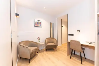 a room with a desk and two chairs at Hotel van Gelder in Amsterdam