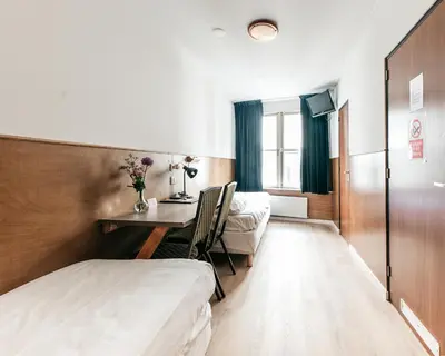 a hotel room with a bed and a desk at Hotel van Gelder in Amsterdam