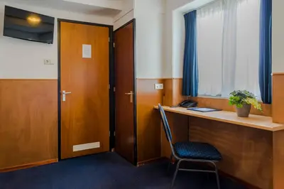 an office with a desk and a chair and a window at Hotel van Gelder in Amsterdam