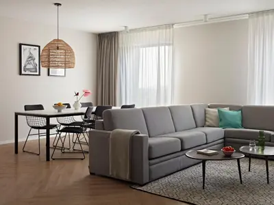 a living room with a couch and a table at Numa Amsterdam Docklands in Amsterdam