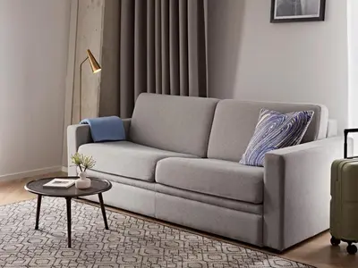 a living room with a couch and a table at Numa Amsterdam Docklands in Amsterdam