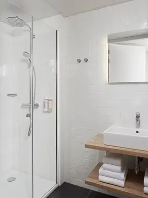 a bathroom with a shower and a sink at Numa Amsterdam Docklands in Amsterdam