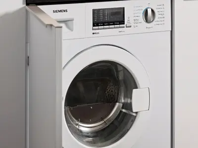 a white washing machine with its door open at Numa Amsterdam Docklands in Amsterdam