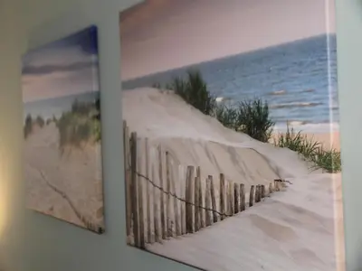a picture of a fence with the beach at Holiday Home in Egmond by the Beach in Egmond aan Zee