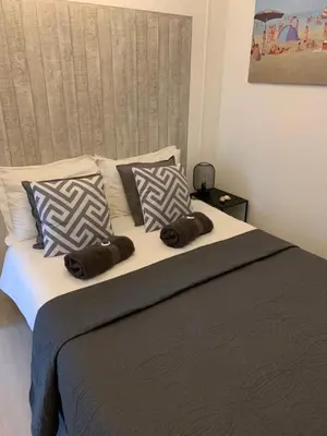 a bed with two brown towels on top of it at De Nollen in Egmond aan den Hoef