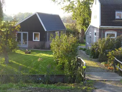 a house with a fence in front of a yard at Beemster Oase in De Beemster