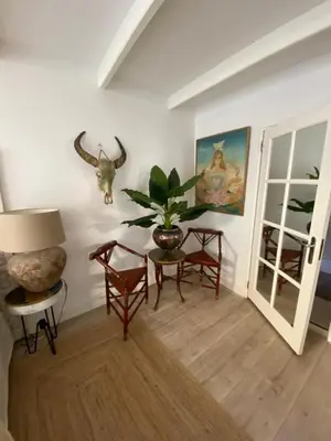 a living room with a table and chairs and a plant at Casa Blanca Old City - Alkmaar in Alkmaar