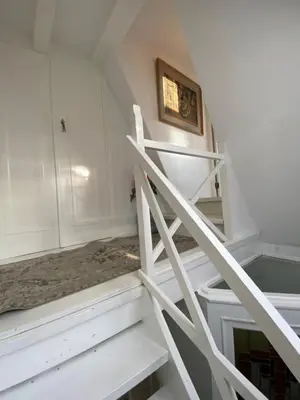 a white staircase in a room with white walls at Casa Blanca Old City - Alkmaar in Alkmaar