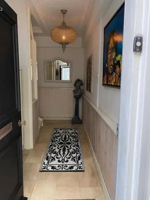 a hallway with a black and white rug on the floor at Casa Blanca Old City - Alkmaar in Alkmaar