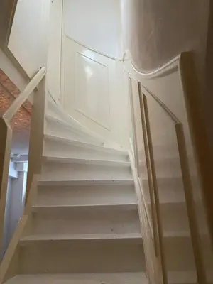 a set of stairs in a room with a door at Casa Blanca Old City - Alkmaar in Alkmaar