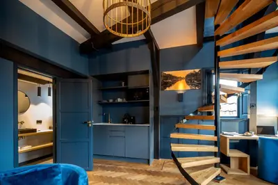 a staircase in a room with blue walls at CTY Books in Leiden