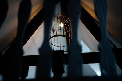 a light hanging from a ceiling in a room at CTY Books in Leiden