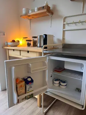 a refrigerator with its door open in a kitchen at Cozy tiny house close to Schiphol Ams Airport in Rijsenhout