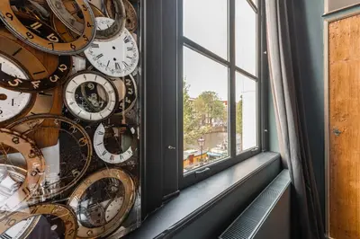 a room with a bunch of clocks on a wall at Boutique Hotel The Craftsmen in Amsterdam
