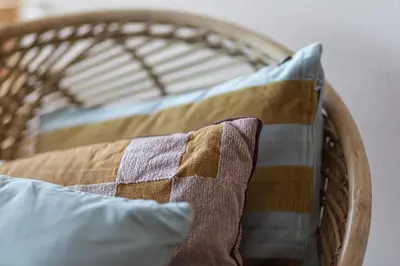a wicker bed with a pillow and a blanket at Strandhotel Zoomers in Castricum