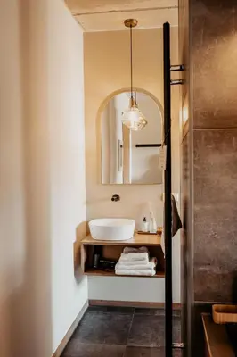 a bathroom with a sink and a mirror at Strandhotel Zoomers in Castricum
