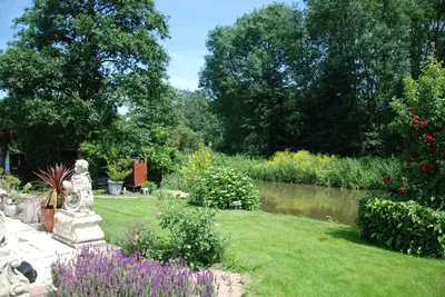 a garden with a statue in the grass at Villa Pantano in Berkhout