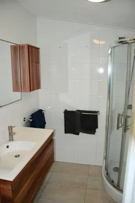 a bathroom with a sink and a shower at Villa Pantano in Berkhout