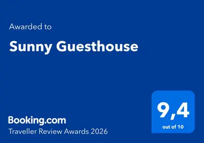 a blue sign that reads sunny guesthouse with the number at Sunny Guesthouse in Bergen
