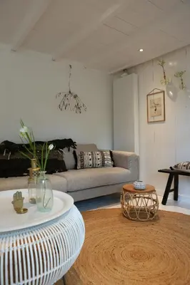 a living room with a couch and a table at Sunny Guesthouse in Bergen