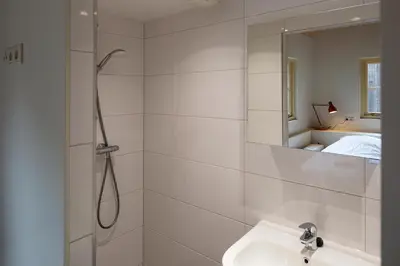a bathroom with a shower and a sink at Bosvilla Kennemerduinen in IJmuiden