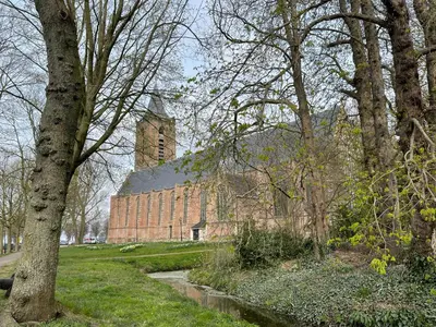 a large brick building with a tower in the distance at Luxury Chalets Monnickendam in Monnickendam