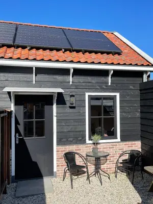a house with solar panels on the roof at Luxury Chalets Monnickendam in Monnickendam