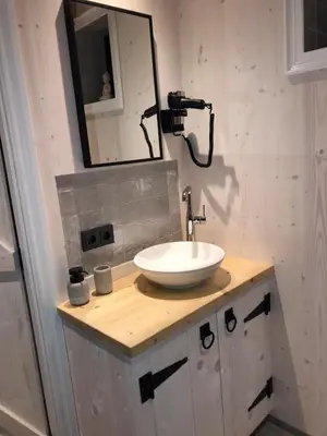a bathroom with a sink and a mirror at Luxury Chalets Monnickendam in Monnickendam