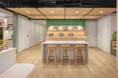 a kitchen with a counter and stools in a room at Maxhotel Amsterdam Airport Schiphol - Recently Renovated in Hoofddorp