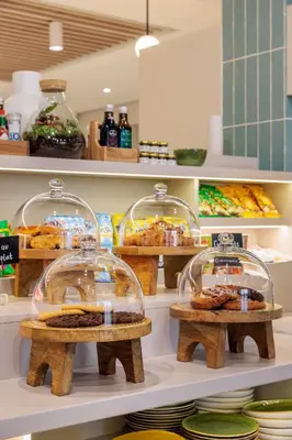 a display case in a store with some food at Maxhotel Amsterdam Airport Schiphol - Recently Renovated in Hoofddorp