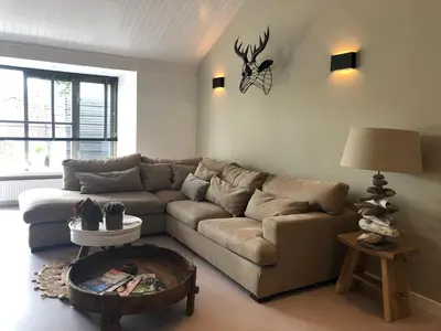 a living room with a couch and a table at Bergenshofje in Bergen