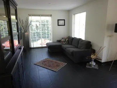 a living room with a couch and a window at Holiday Home Zeewolde in Zeewolde