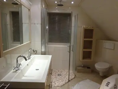 a bathroom with a sink and a shower and a toilet at Holiday Home Zeewolde in Zeewolde