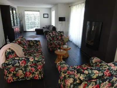 a living room with two couches and a table at Holiday Home Zeewolde in Zeewolde