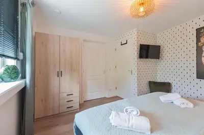 a bedroom with a bed with towels on it at KUST Zandvoort Private Parking included in Zandvoort