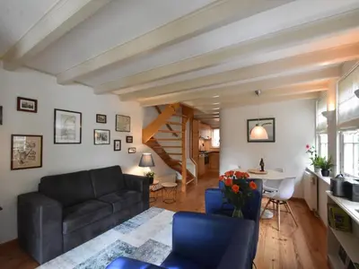a living room with a couch and a table at Serene Getaway in Edam in Edam