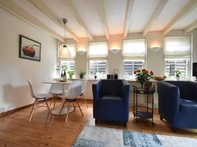 a living room with blue chairs and a table at Serene Getaway in Edam in Edam