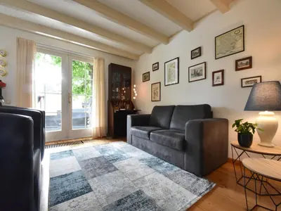 a living room with a couch and a table at Serene Getaway in Edam in Edam