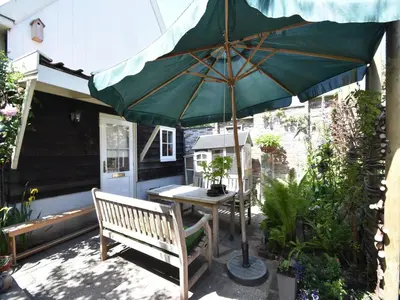 a patio with a table and an umbrella at Serene Getaway in Edam in Edam